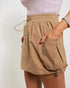 Tan shorts worn by a person on a plain background