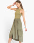 A woman modeling a sleeveless olive green dress with a fitted bodice, gathered elastic waist, and large front cargo pockets, photographed against a plain light background.
