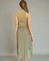 Woman wearing an olive green dress against a gray background