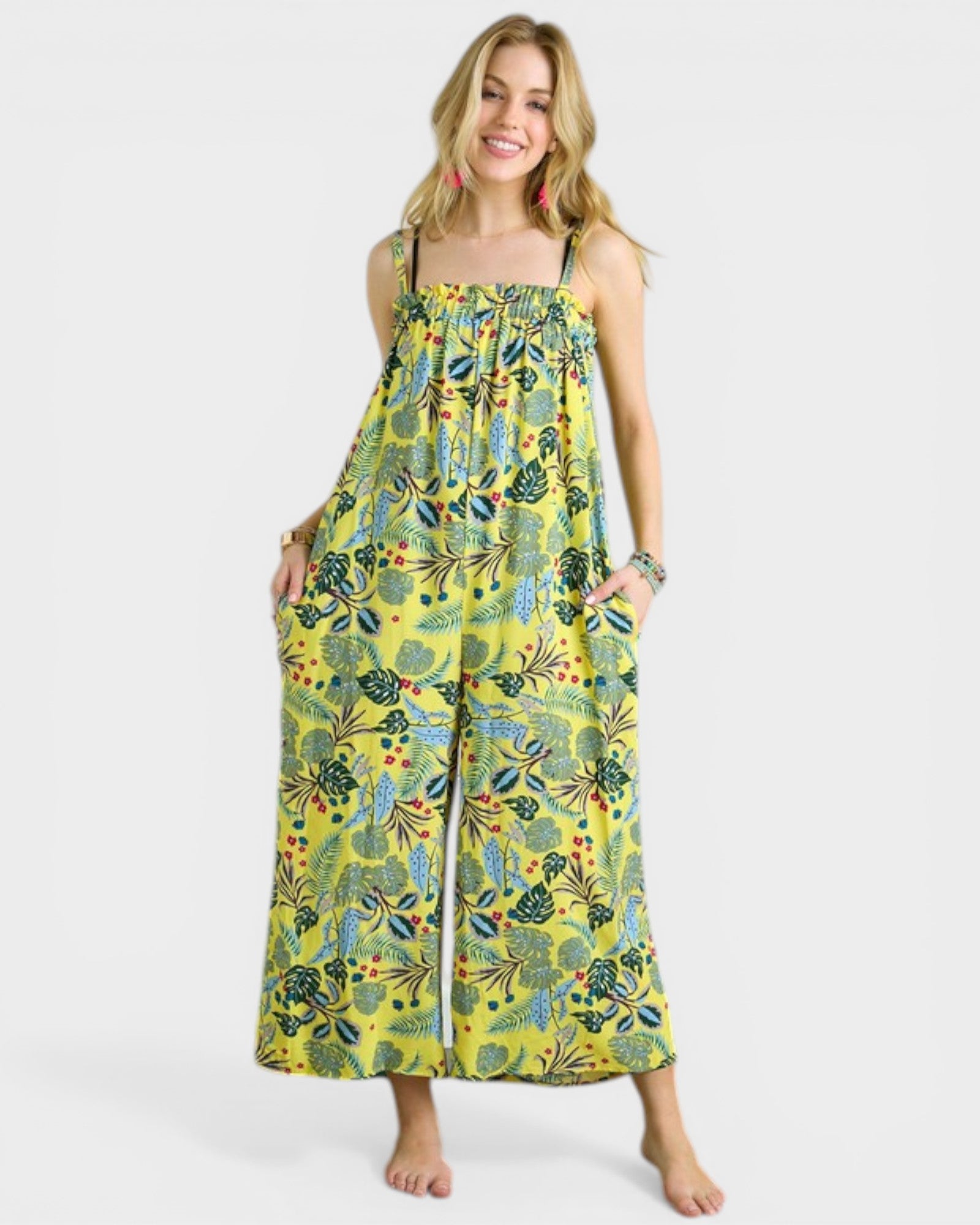 Woman wearing a yellow floral dress on a white background