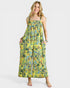 Woman wearing a yellow floral dress on a white background