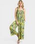Woman wearing a yellow floral jumpsuit on a white background
