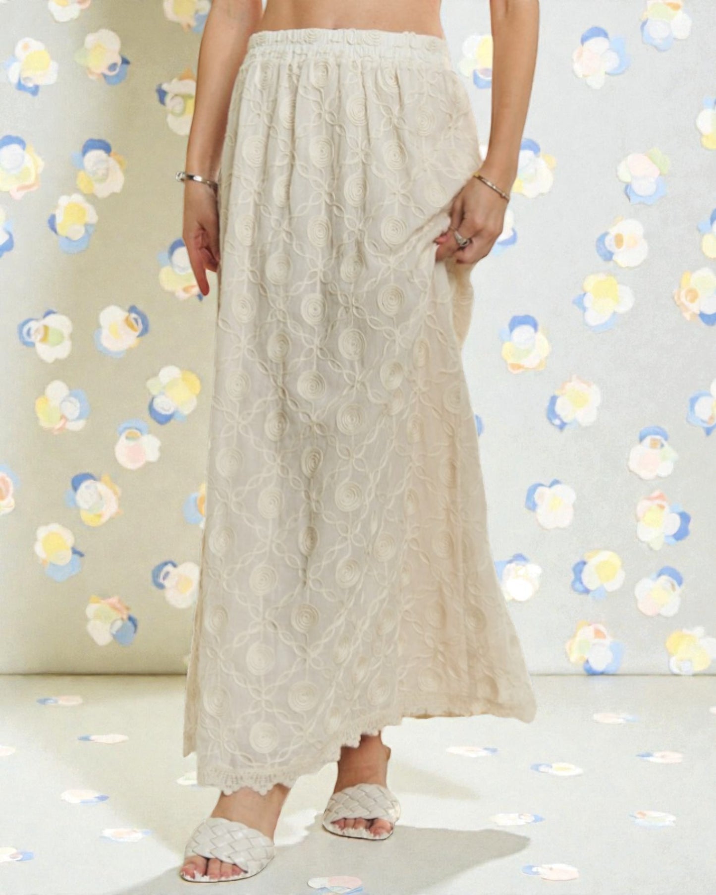 Person wearing a beige skirt with a colorful polka dot background