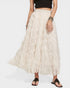 Person wearing a long beige skirt on a white background