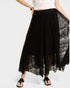 Black lace skirt with a white top and sandals on a white background