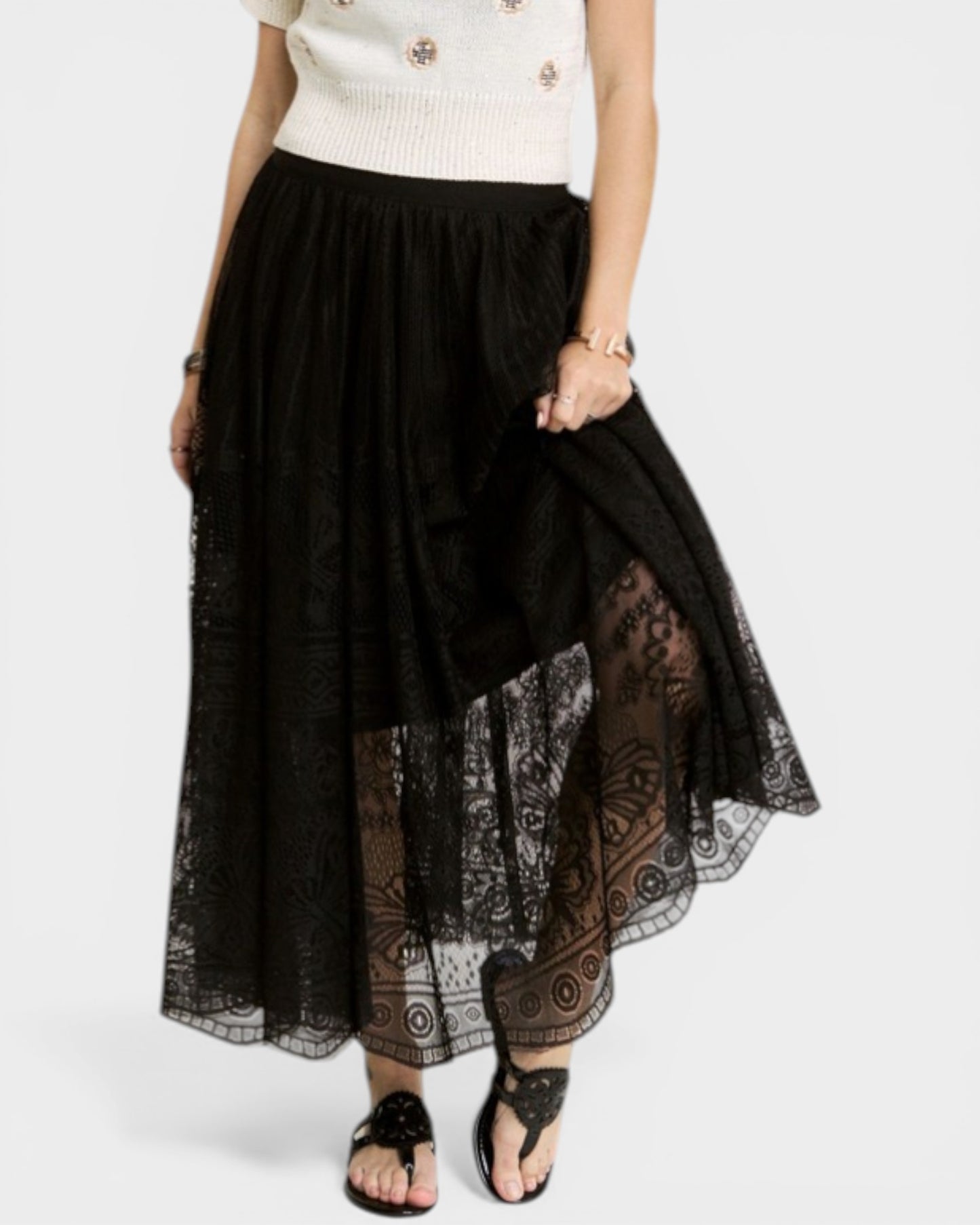 Black lace skirt with patterned hem on a white background