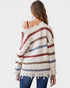 Woman wearing a striped sweater with a white background