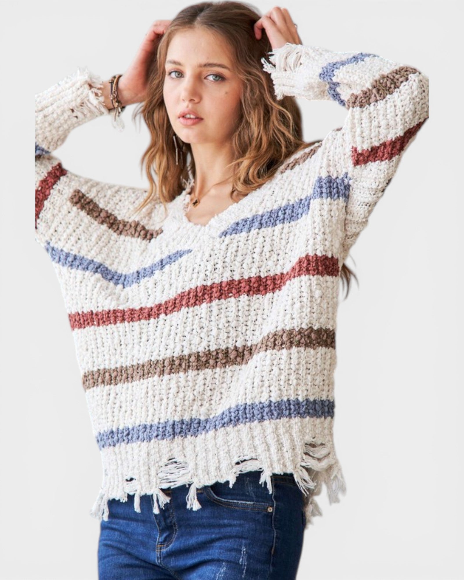 Woman wearing a striped sweater with a white background