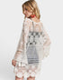 Woman wearing a white crochet dress on a white background