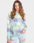Woman wearing a light blue sweater with floral patterns on a white background