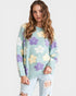 Woman wearing a light blue sweater with floral patterns on a white background