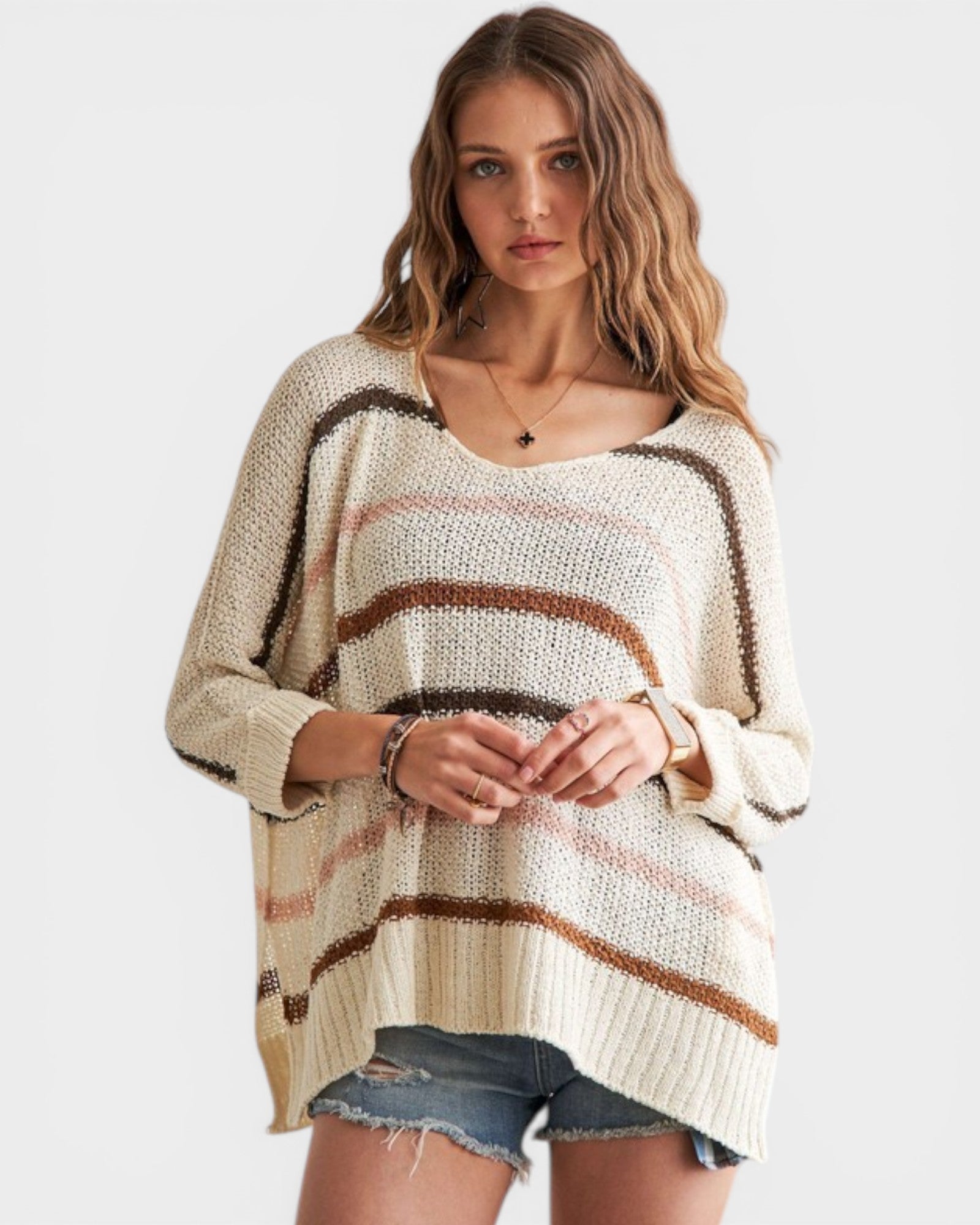 Woman wearing a striped sweater with a plain background