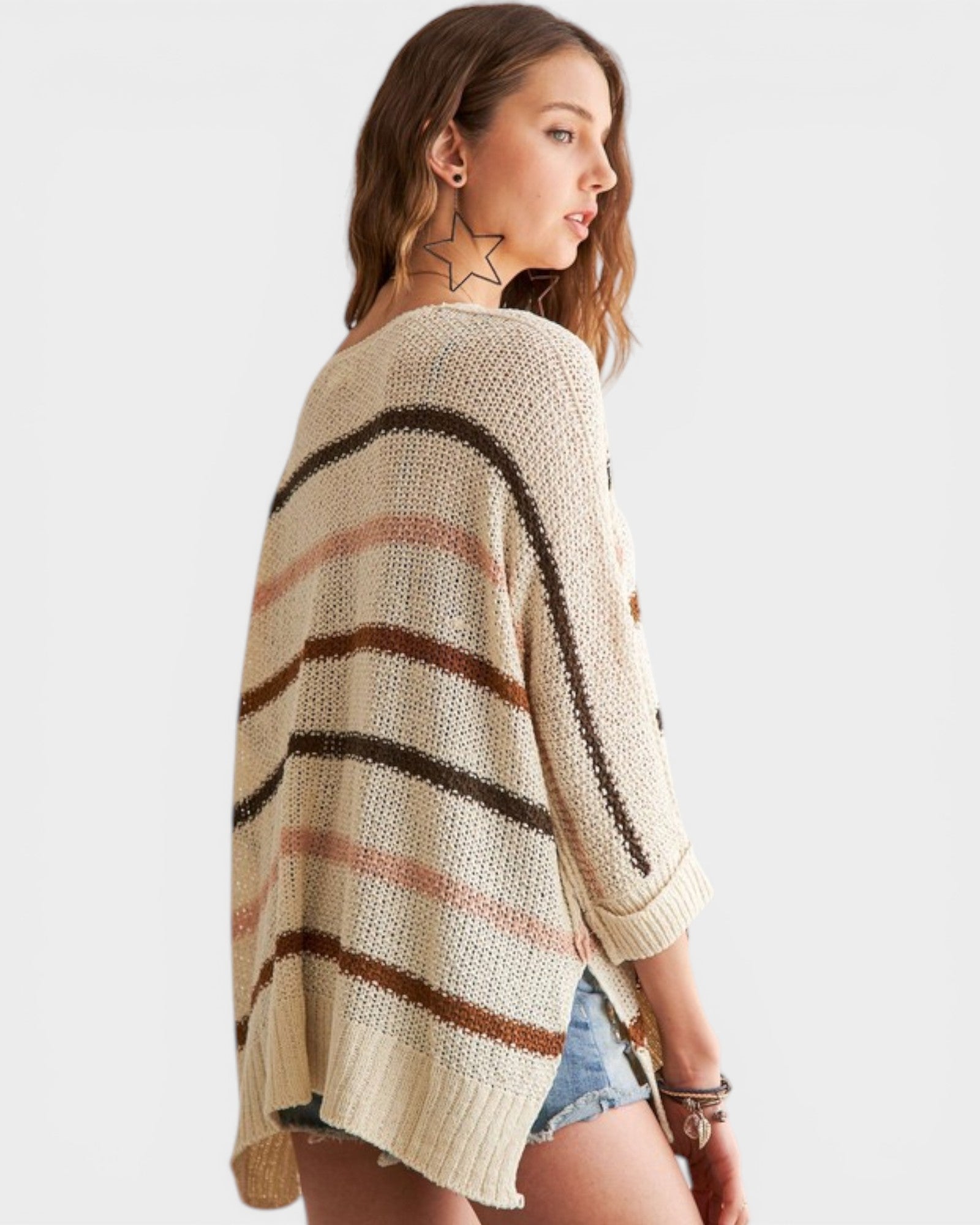 Woman wearing a striped sweater with a neutral background