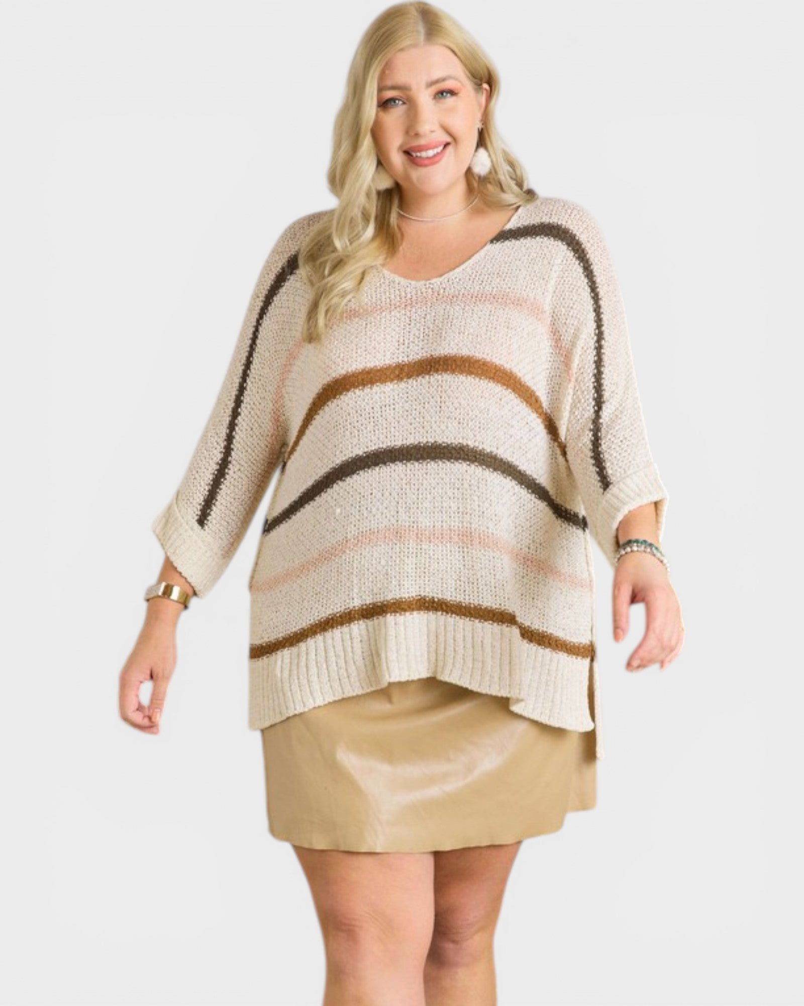 Woman wearing a striped sweater and beige skirt on a white background