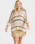 Woman wearing a striped sweater and beige skirt on a white background