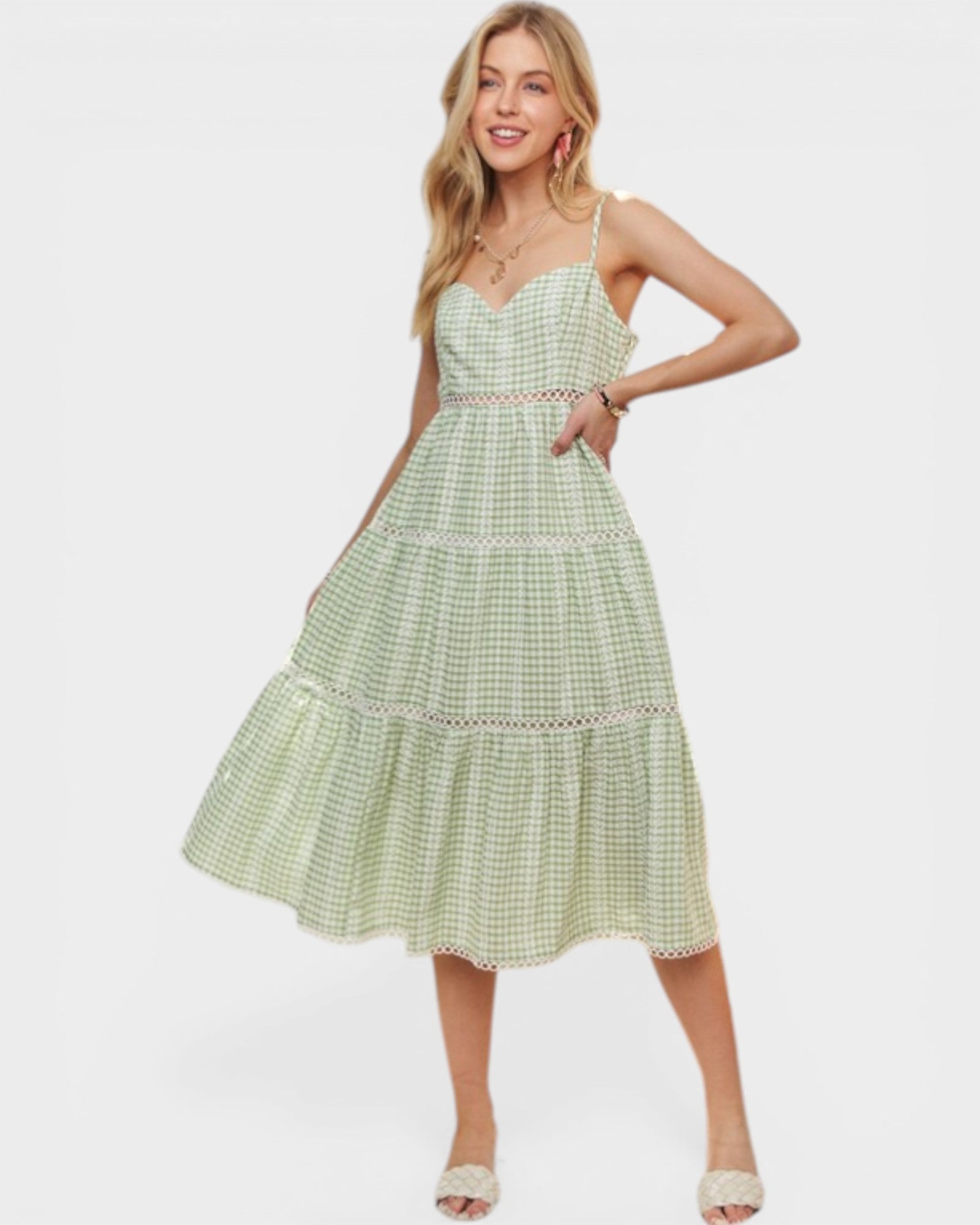Woman wearing a green checkered dress on a white background