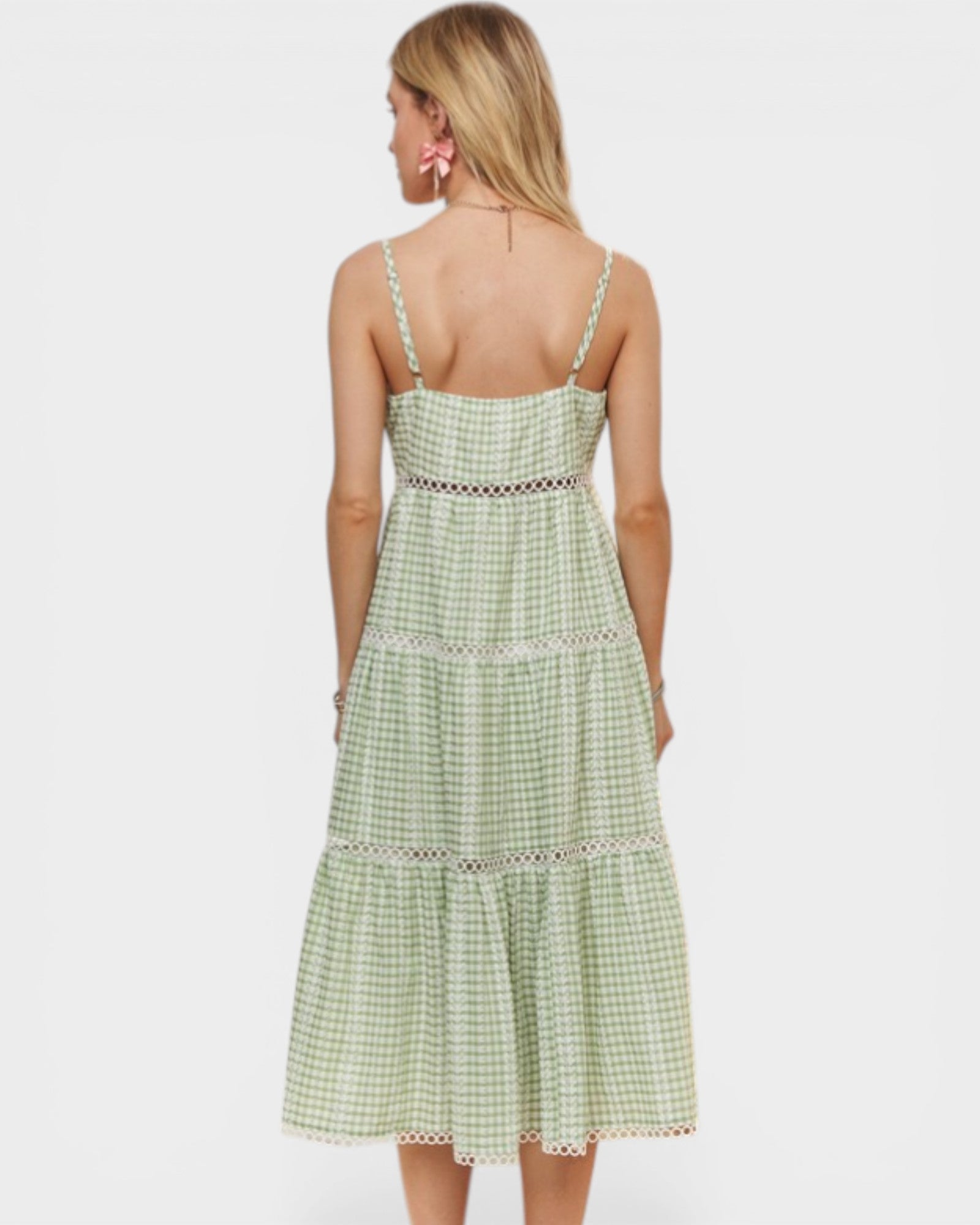 Woman wearing a green checkered dress on a white background