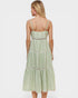 Woman wearing a green checkered dress on a white background