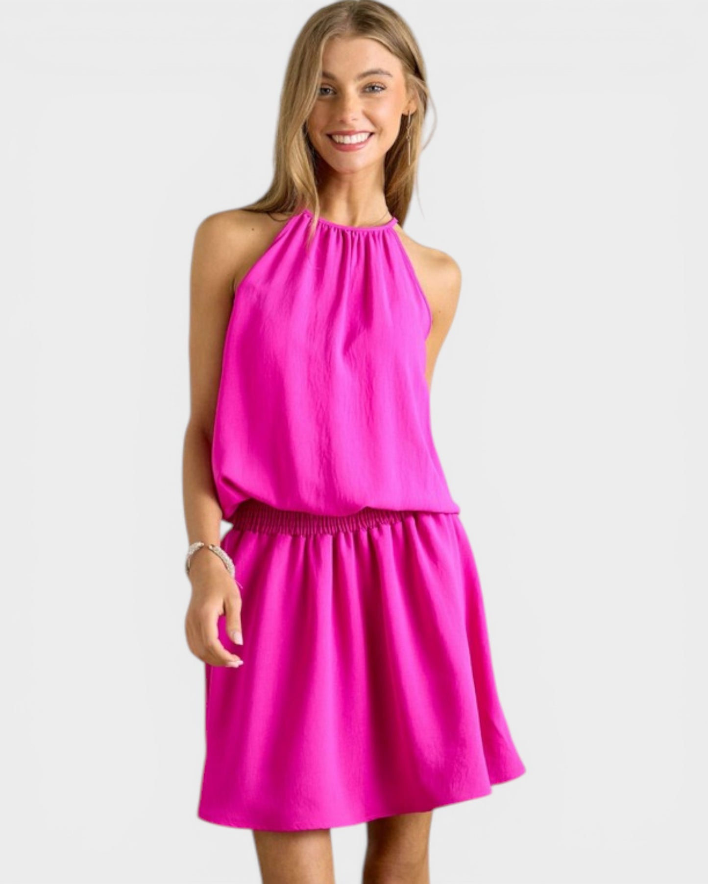 Woman wearing a bright pink dress on a white background