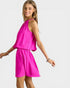 Woman wearing a bright pink dress on a white background