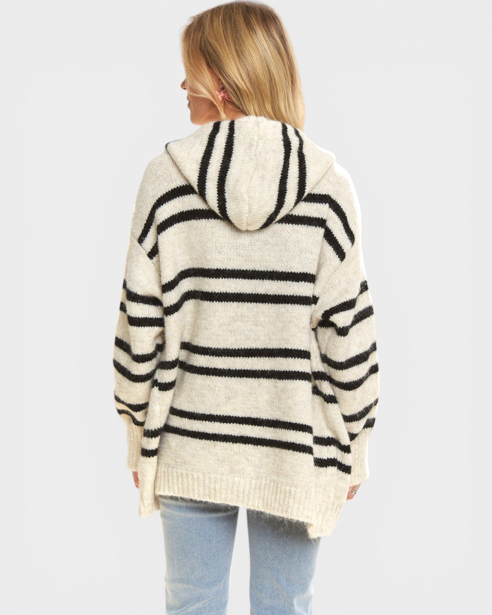 Person wearing a striped hoodie with a plain background