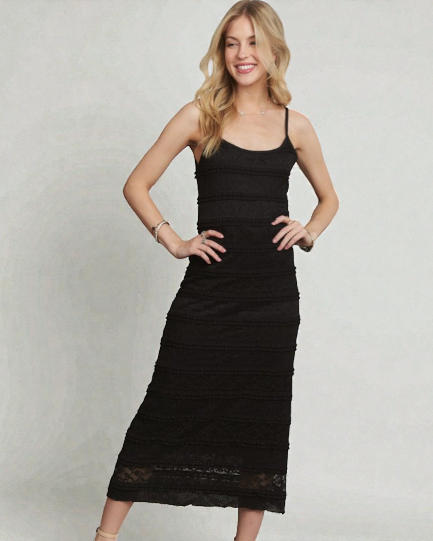 Woman wearing a black dress against a plain background