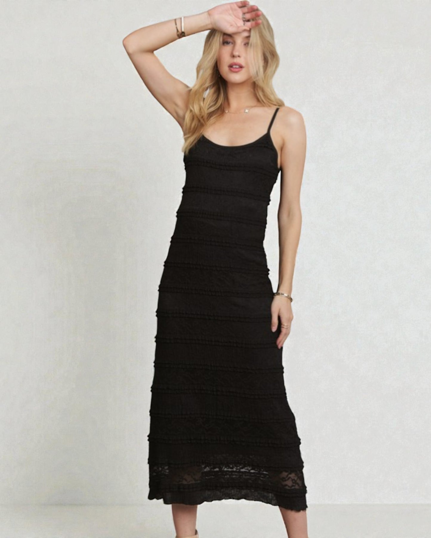 Woman wearing a black dress against a plain background