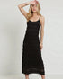 Woman wearing a black dress against a plain background
