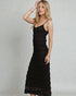 Woman wearing a black dress against a plain background