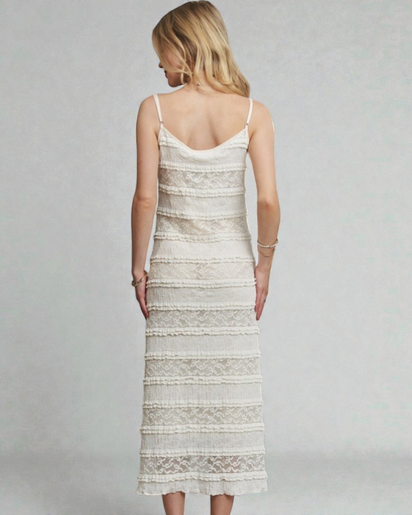 Woman wearing a white lace dress on a gray background