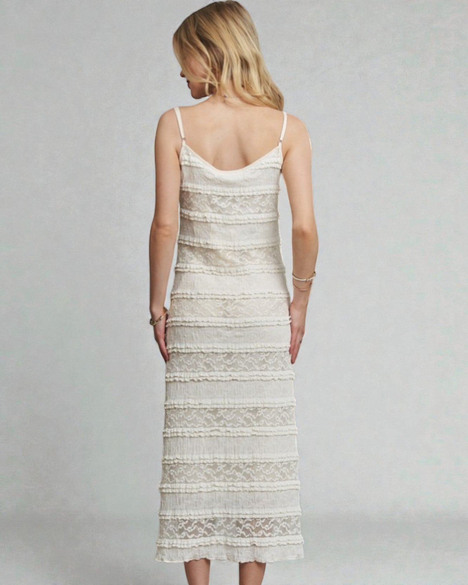 Woman wearing a white lace dress on a gray background