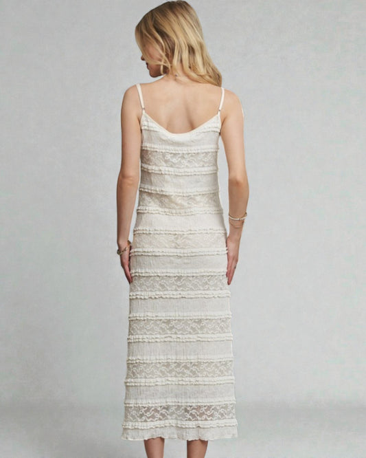 Woman wearing a white lace dress on a gray background