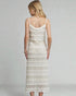 Woman wearing a white lace dress on a gray background