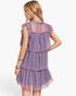 A woman modeling a lavender purple tiered tulle dress from the back, featuring ruffled cap sleeves and a sheer mesh back panel, against a plain white background.