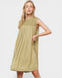 Woman wearing a light green dress on a plain background