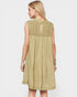 Woman wearing a light green dress with lace details on a white background