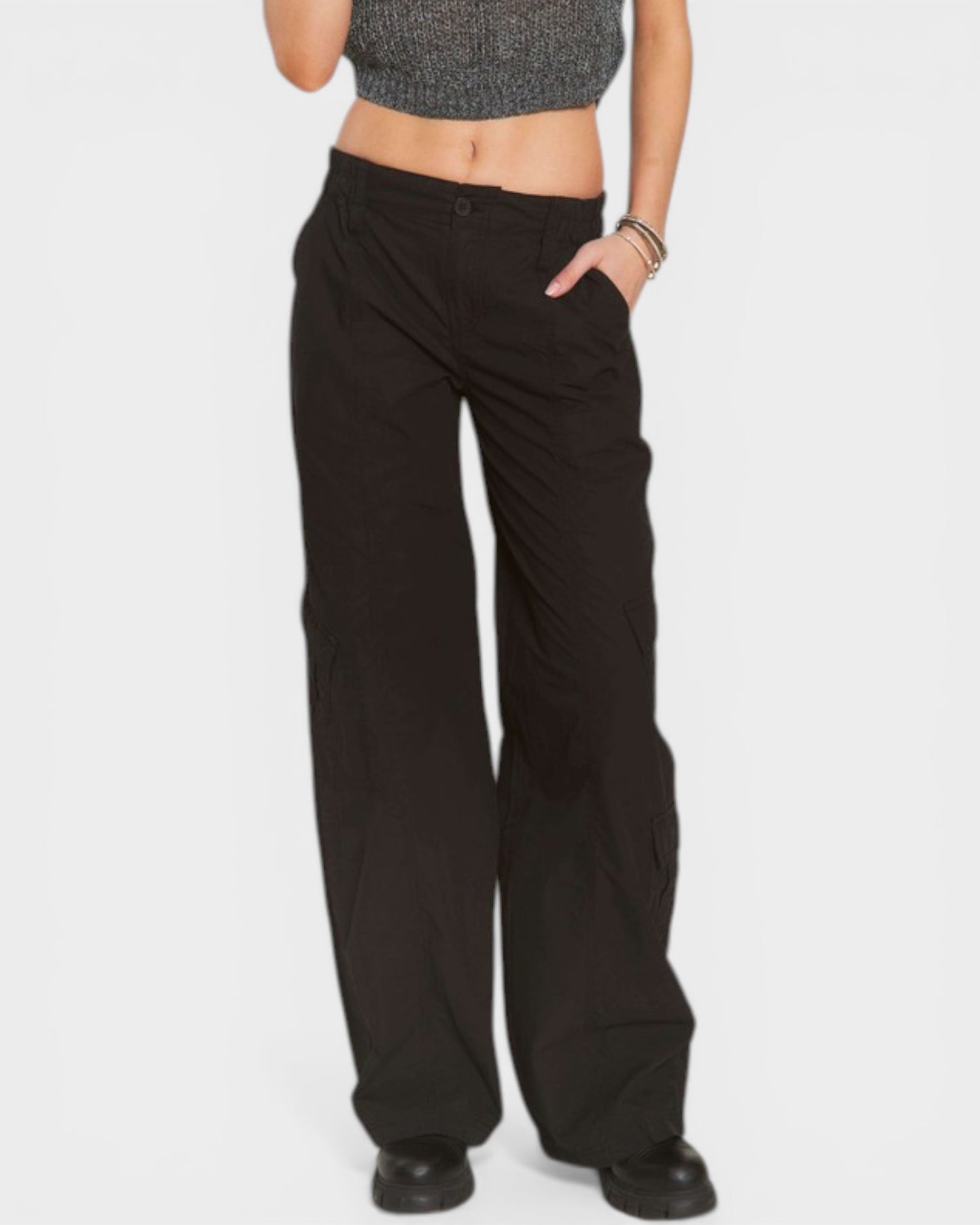 Person wearing black wide-leg pants on a white background