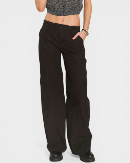 Person wearing black wide-leg pants on a white background