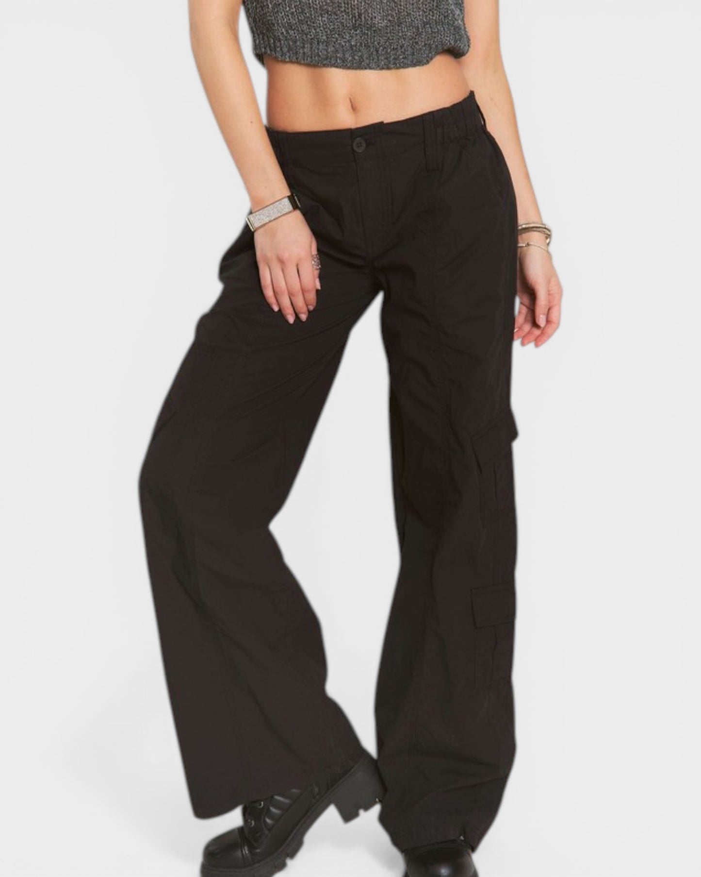 Person wearing black wide-leg pants on a white background