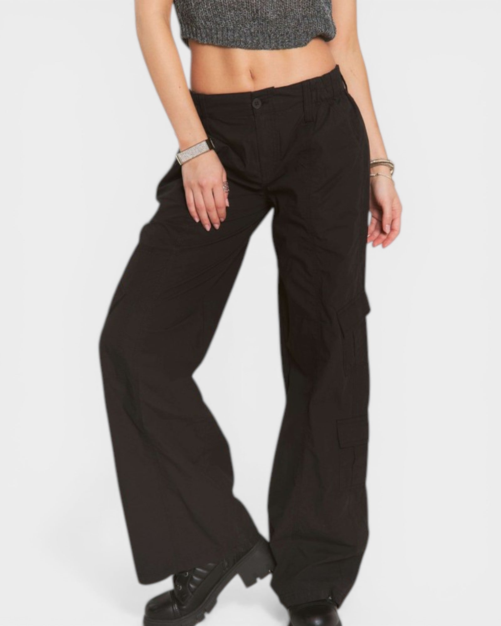 Person wearing black wide-leg pants on a white background