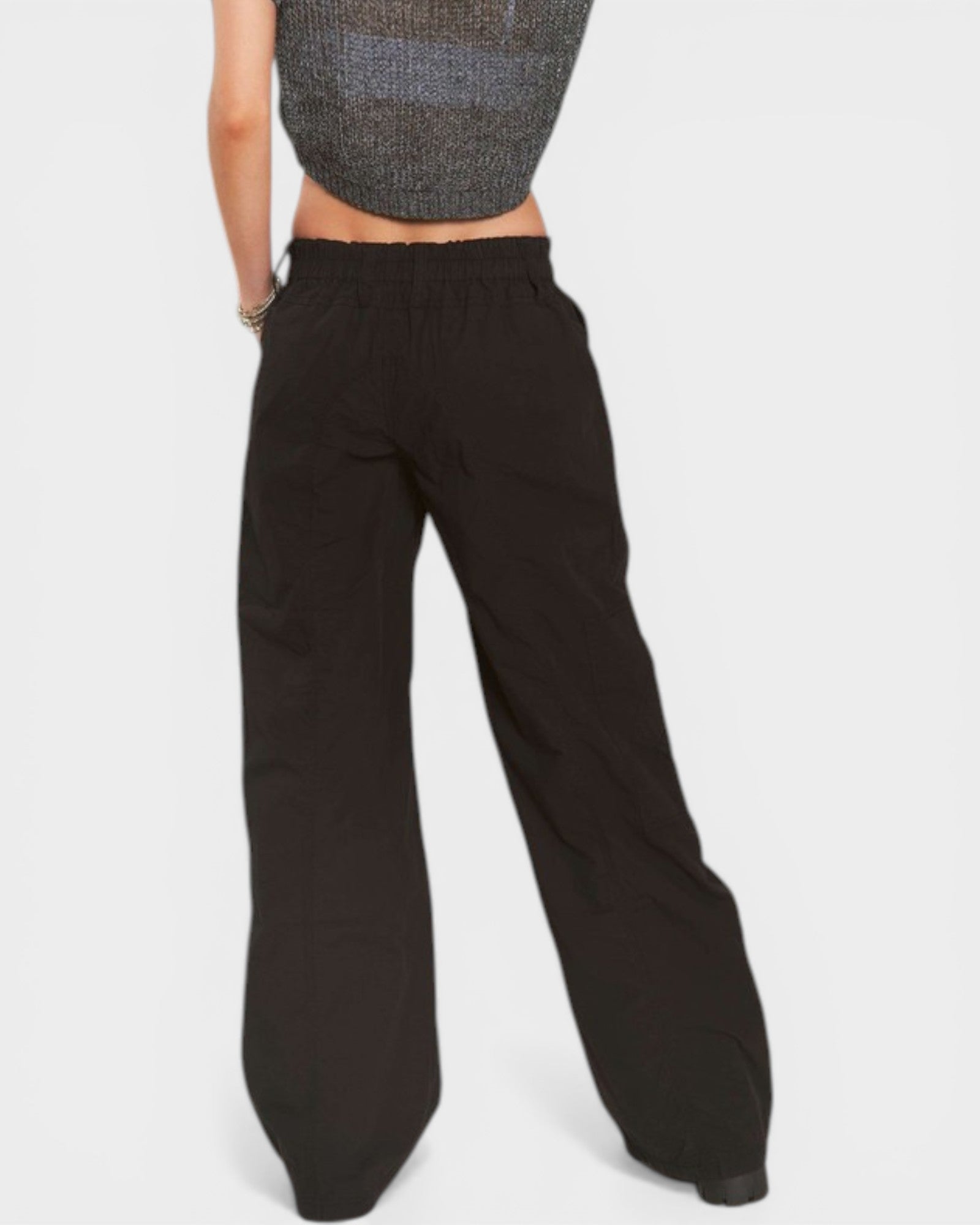 Black wide-leg pants worn by a person on a light gray background