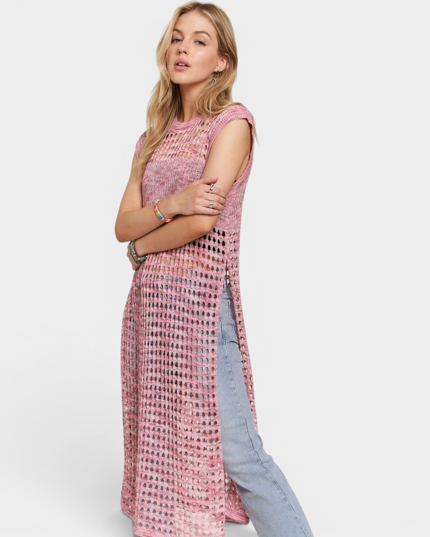Woman wearing a pink patterned dress with a white background