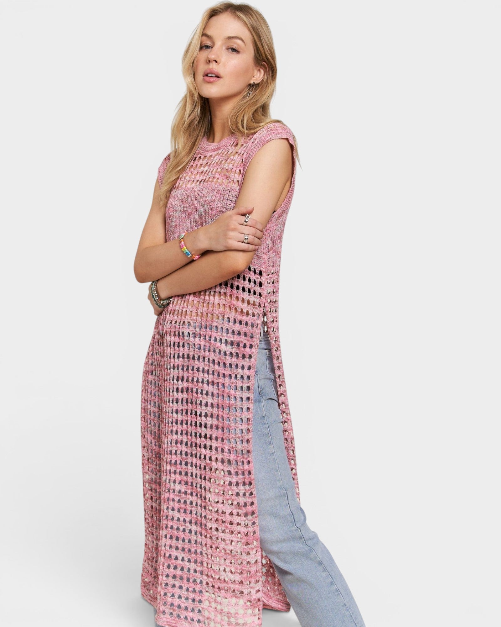 Woman wearing a pink patterned dress with a white background
