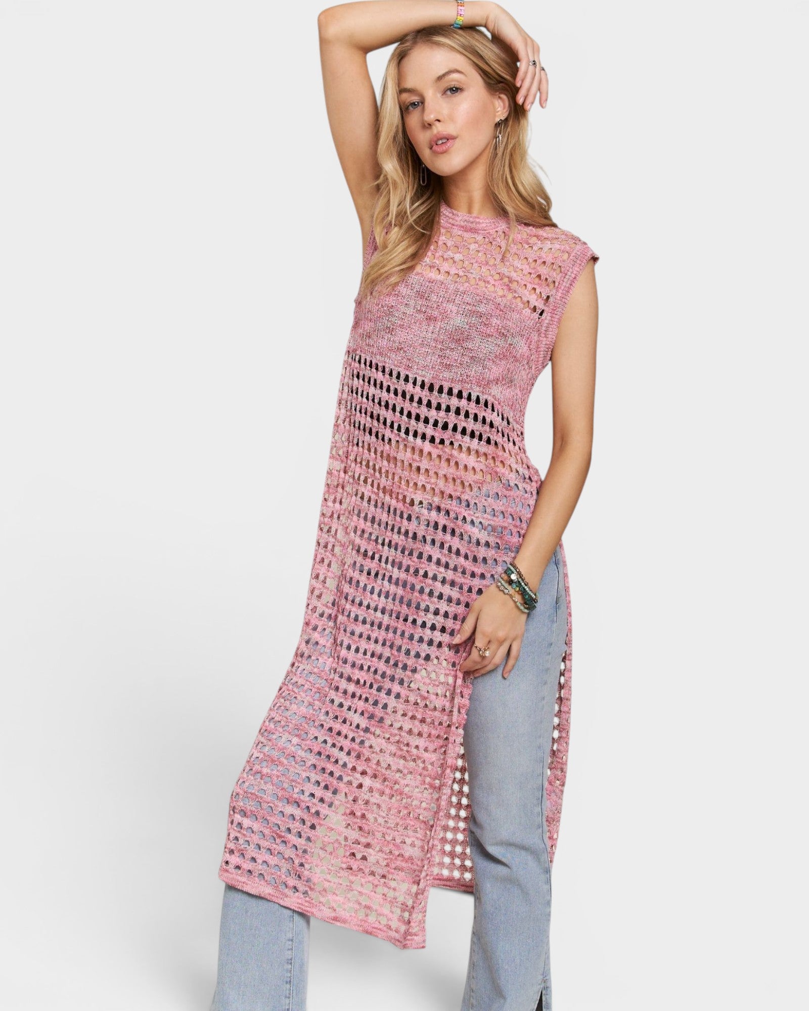 Woman wearing a pink patterned dress with a white background