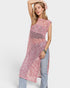 Woman wearing a pink patterned dress with a white background