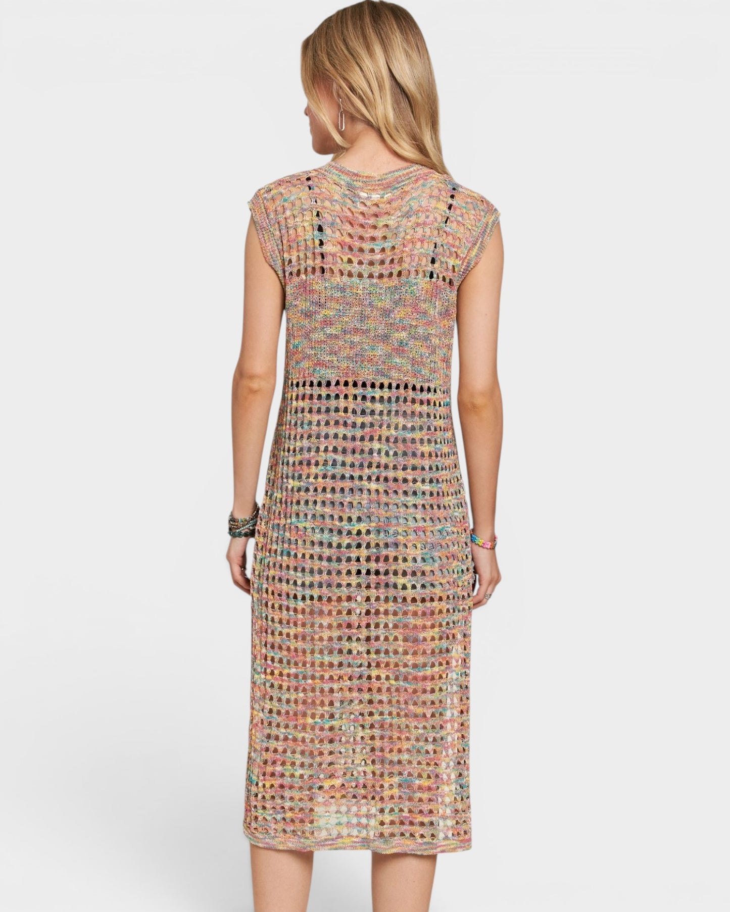 Woman wearing a colorful patterned dress on a white background