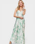 Woman wearing a green floral dress on a white background