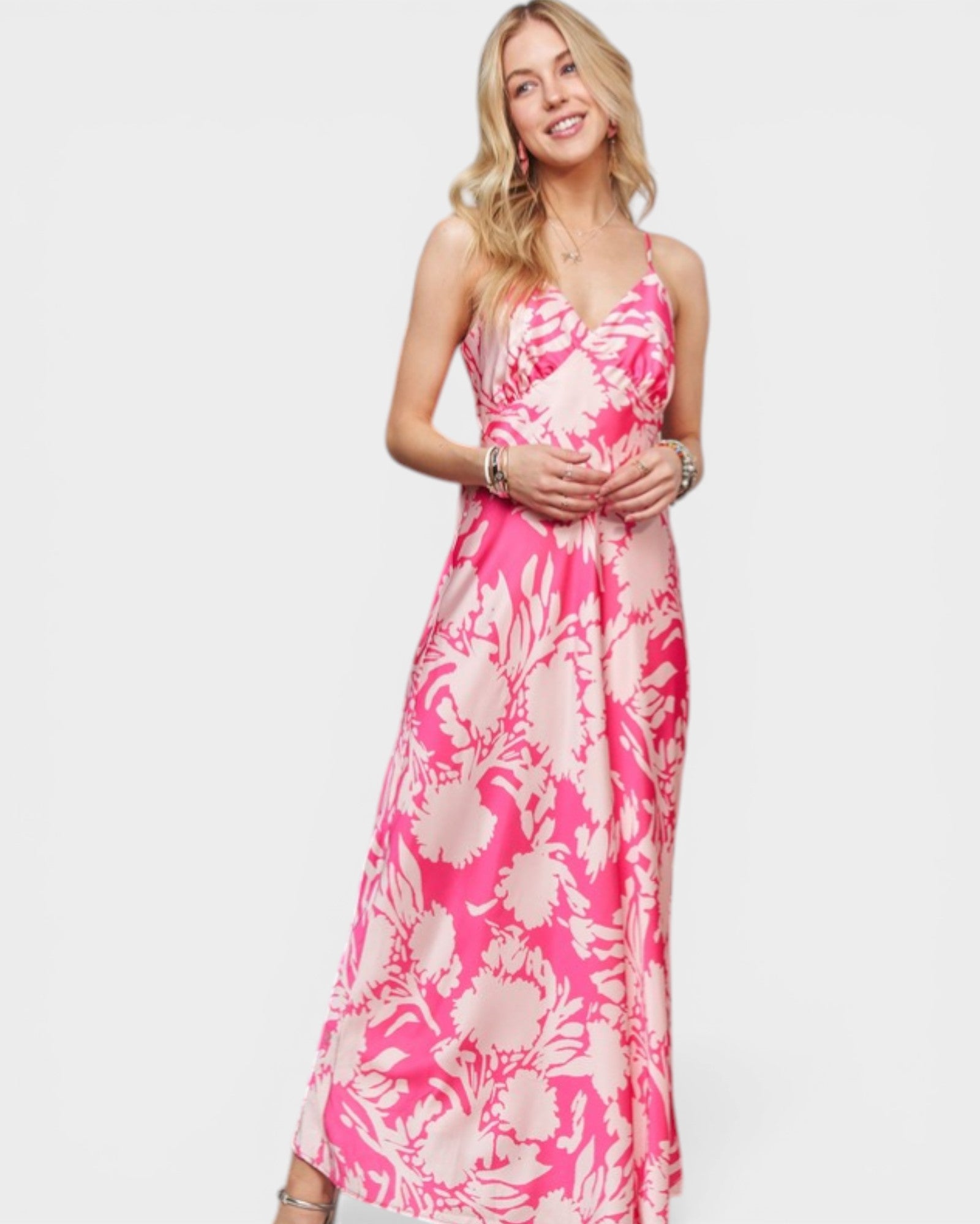 Woman wearing a pink floral dress on a white background