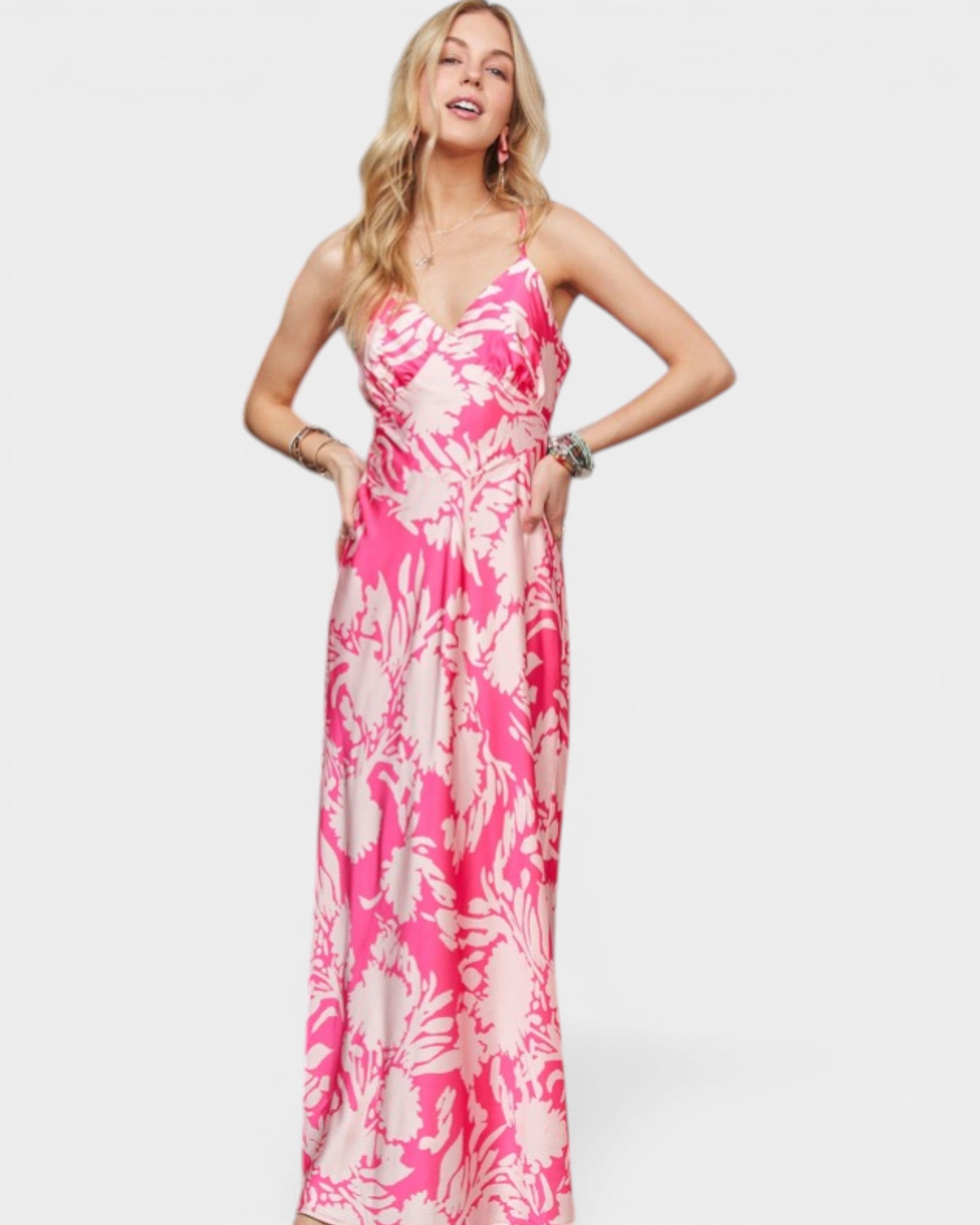 Woman wearing a pink floral dress on a white background