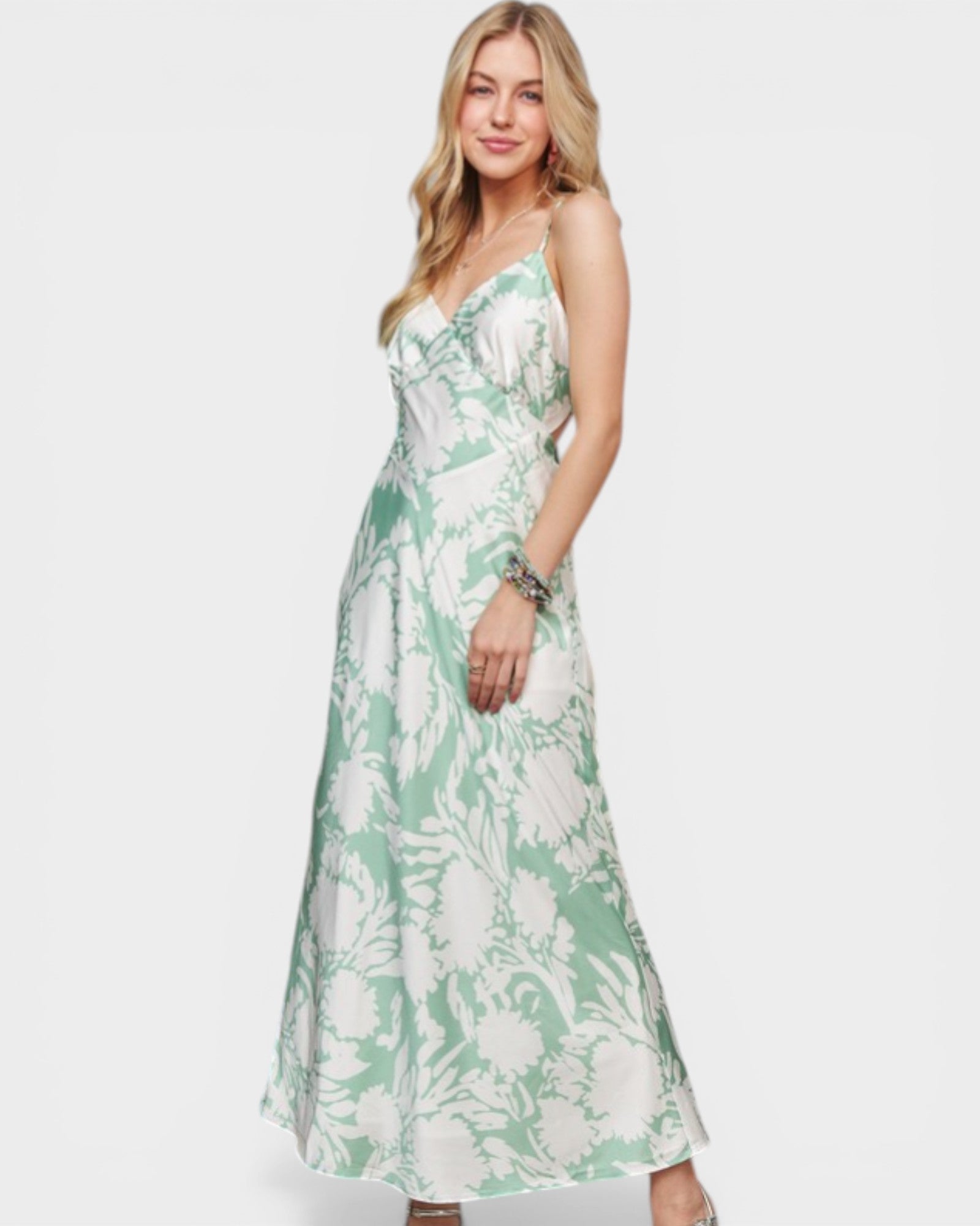 Woman wearing a green floral dress on a white background